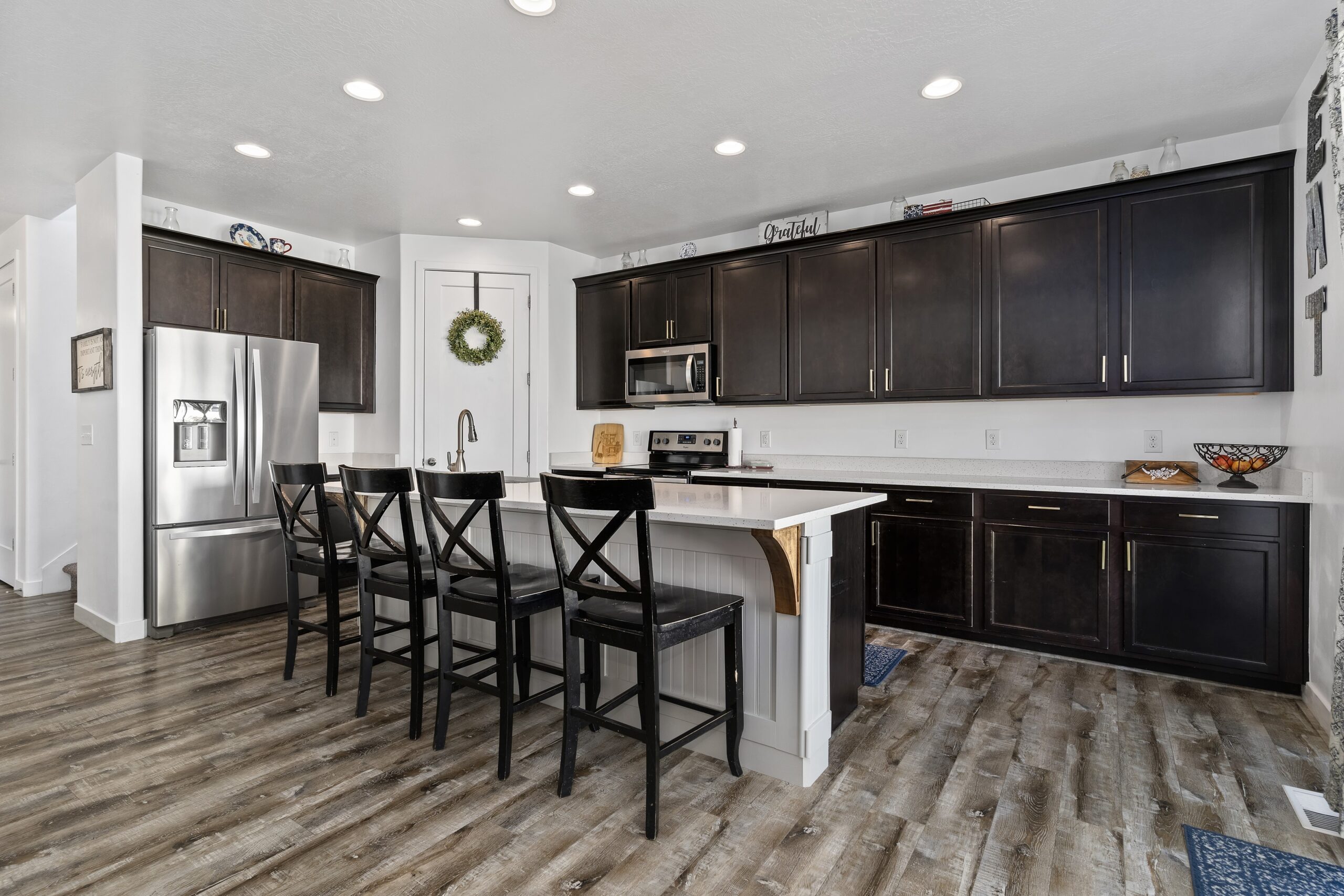 Modern kitchen of a Home for Sale in Layton Utah featuring lots of cabinetry and large kitchen island...